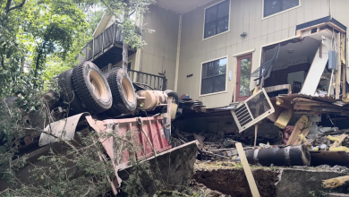 Photo of Dump truck crashes through house